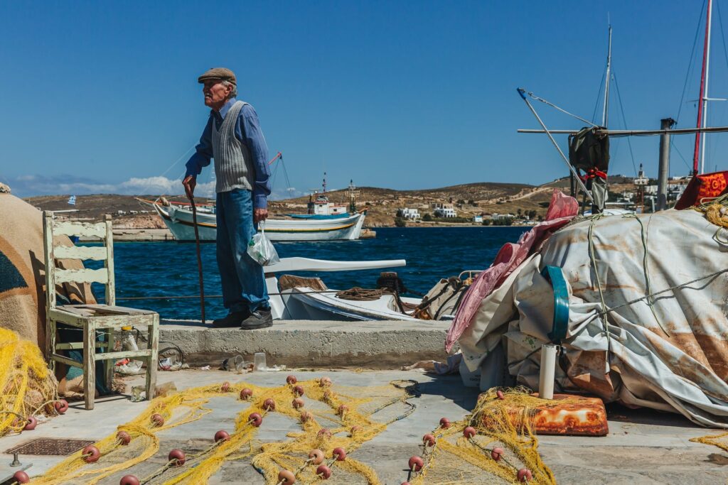 Old man walking in the port of Parikia, Paros island