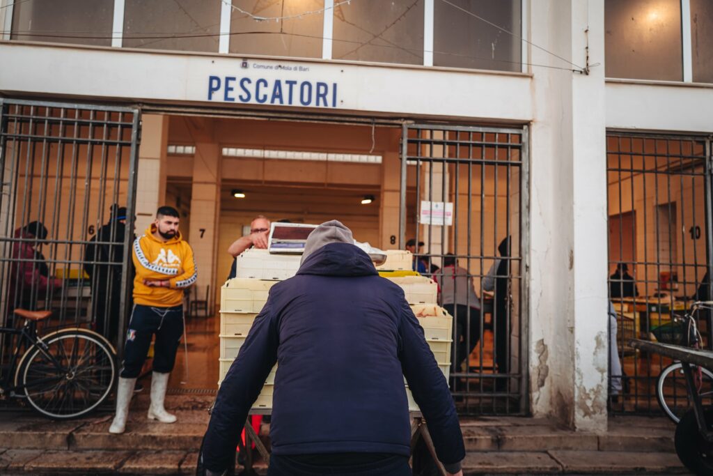 Mola di Bari, Italy - January 2023: local life scene by the fish market and the main harbor