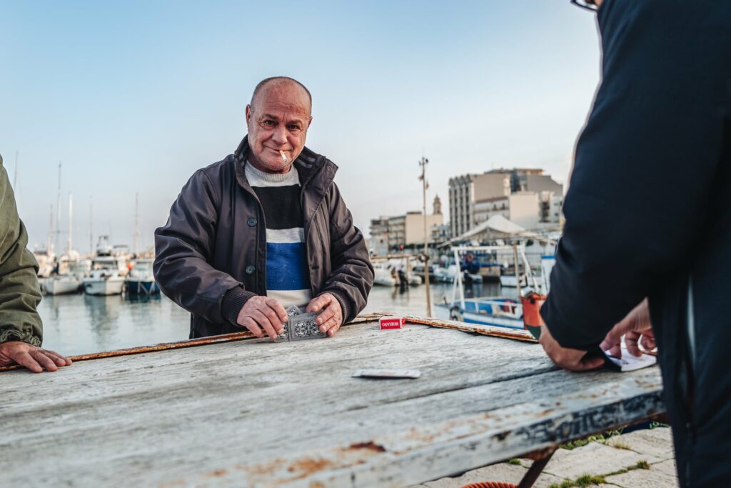 Mola di Bari, Italy - January 2023: local life scene by the fish market and the main harbor